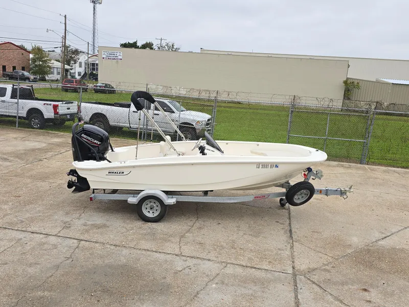 Slide: The Image of 2022 Boston Whaler 160 Super Sport boat on trailer in parking lot. - 3