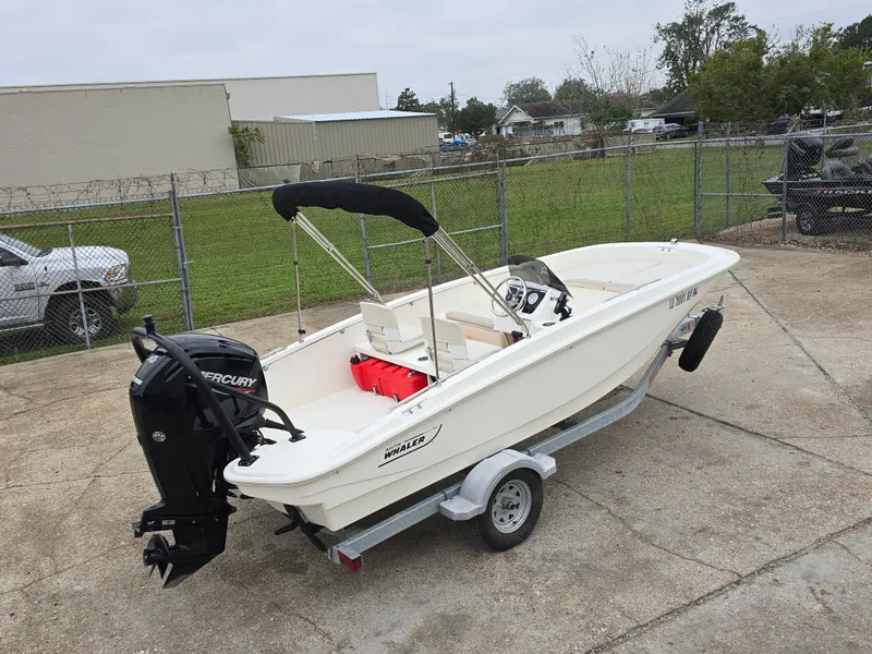 Slide: The Image of 2022 Boston Whaler 160 Super Sport boat on trailer, parked outdoors. - 5