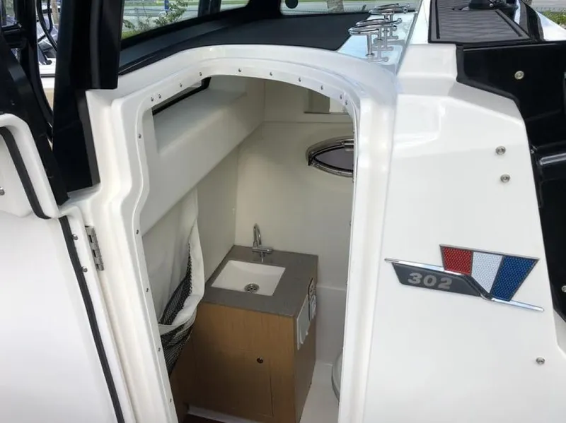 Slide: The Image of 2018 Wellcraft 302 Fisherman boat interior with compact sink and storage. - 14