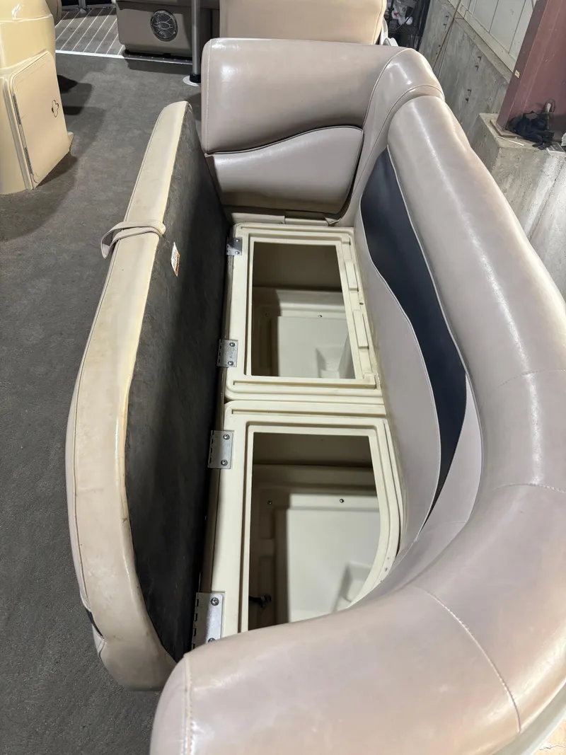 Slide: The Image of 2015 Godfrey Sweetwater 2286 boat seat with open storage compartments. - 10