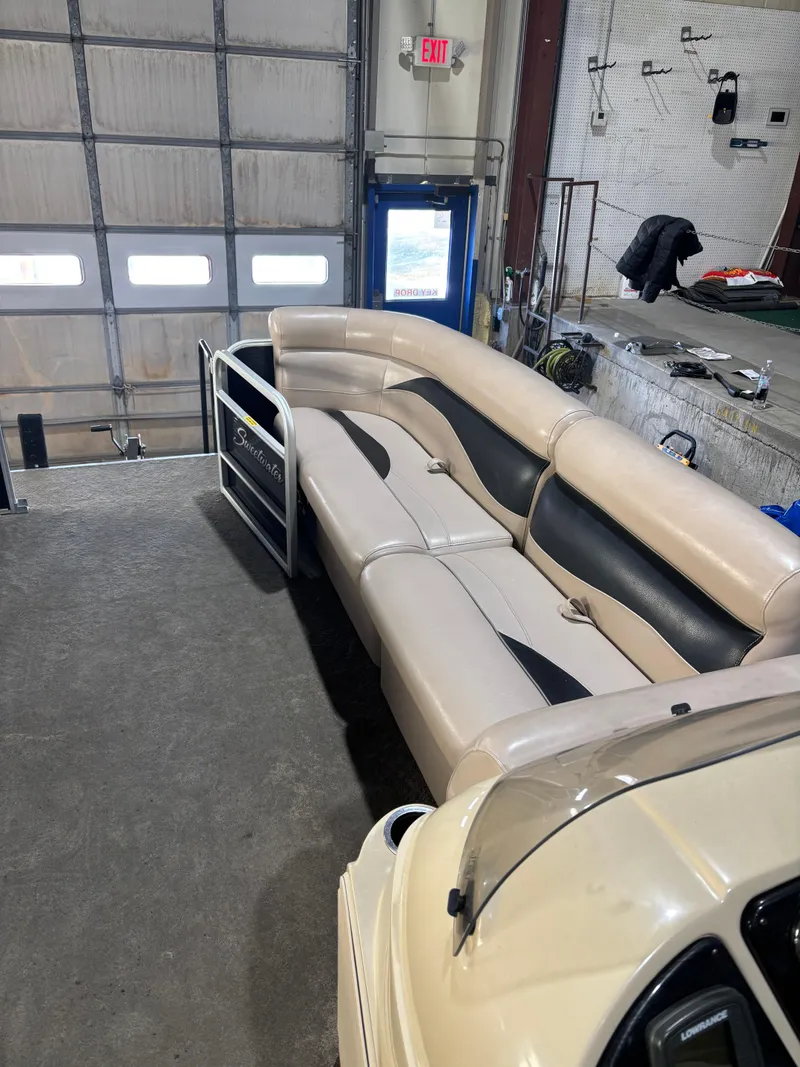 Slide: The Image of 2015 Godfrey Sweetwater 2286 pontoon boat interior with beige and black seating. - 7