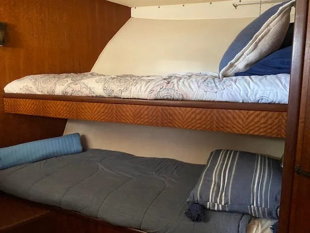 Slide: The Image of 1973 Hatteras Motor Yacht cabin with cozy bunk beds and nautical decor. - 12