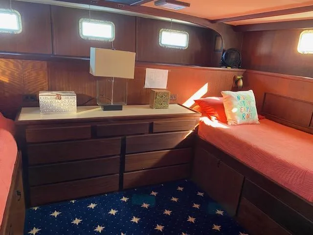 Slide: The Image of Cozy 1973 Hatteras Motor Yacht cabin with twin beds and nautical decor. - 13