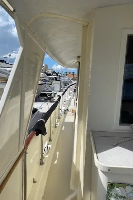 Slide: The Image of 1973 Hatteras Motor Yacht deck view with marina background. - 15