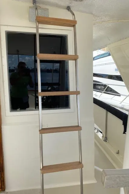 Slide: The Image of Ladder on 1973 Hatteras Motor Yacht with window view. - 16