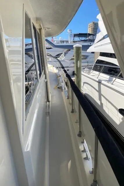 Slide: The Image of 1973 Hatteras Motor Yacht deck view with marina background. - 17