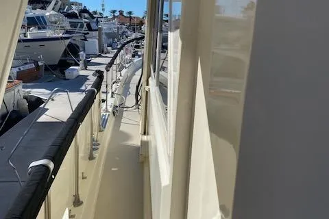 Slide: The Image of 1973 Hatteras Motor Yacht docked at marina, side view with railing. - 18