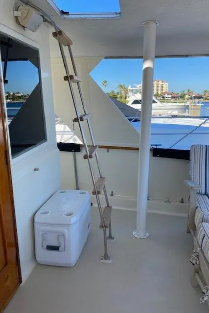 Slide: The Image of 1973 Hatteras Motor Yacht interior with ladder, cooler, and seating area. - 20