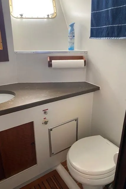 Slide: The Image of 1973 Hatteras Motor Yacht bathroom with modern fixtures and wooden accents. - 28