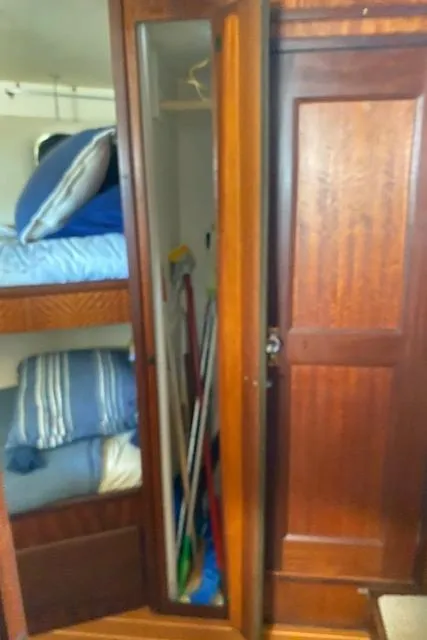 Slide: The Image of 1973 Hatteras Motor Yacht interior with wooden closet and bunk beds. - 32