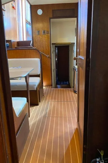 Slide: The Image of Interior of a 1973 Hatteras Motor Yacht with wood paneling and seating area. - 35