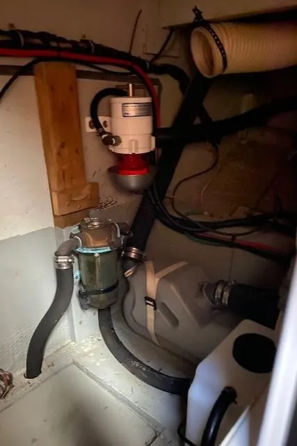 Slide: The Image of 1973 Hatteras Motor Yacht engine room with hoses and equipment. - 38