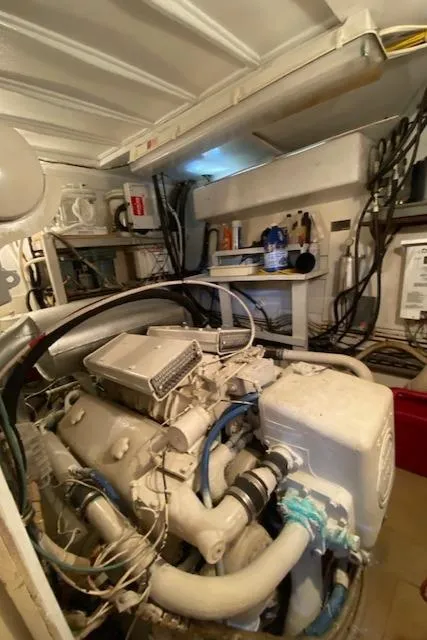 Slide: The Image of Engine room of a 1973 Hatteras Motor Yacht with visible machinery and wiring. - 40