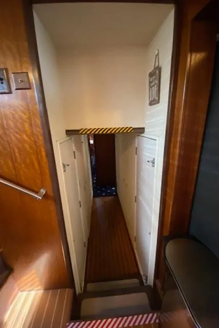 Slide: The Image of Narrow hallway inside a 1973 Hatteras Motor Yacht with wooden paneling. - 41