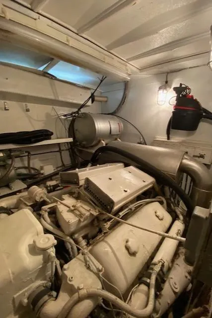 Slide: The Image of Engine room of a 1973 Hatteras Motor Yacht, showcasing mechanical components. - 44
