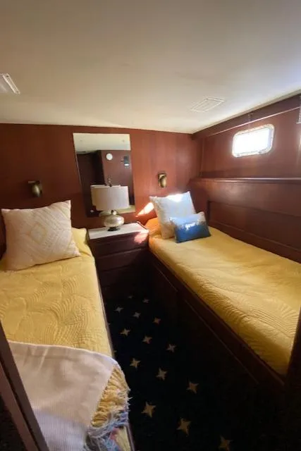 Slide: The Image of 1973 Hatteras Motor Yacht cabin with twin beds, wooden interior, and nautical decor. - 46