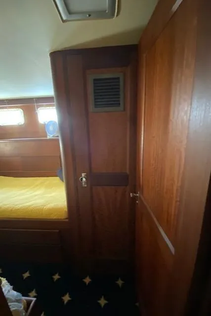 Slide: The Image of Interior of 1973 Hatteras Motor Yacht with wooden paneling and cozy cabin. - 47