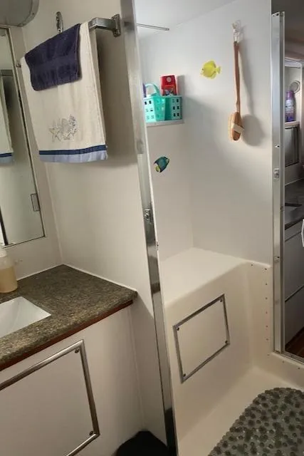 Slide: The Image of 1973 Hatteras Motor Yacht bathroom with modern amenities and nautical decor. - 48