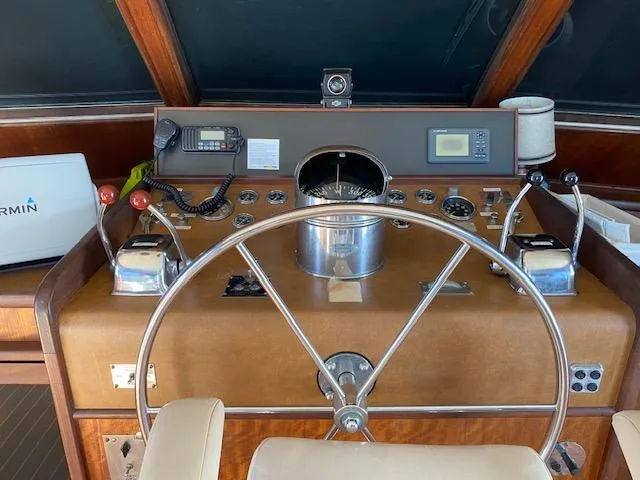 Slide: The Image of 1973 Hatteras Motor Yacht helm with vintage controls and steering wheel. - 9
