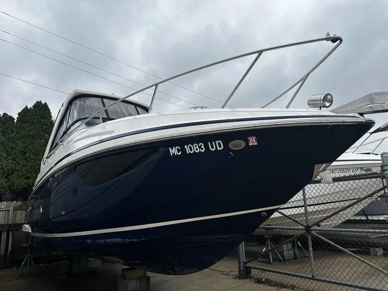 Slide: The Image of 2018 Regal 28 Express boat on dry dock, overcast sky background. - 0