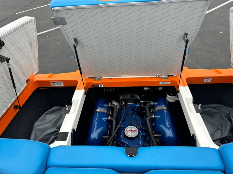 Slide: The Image of 2020 MasterCraft XT22 boat engine compartment with vibrant blue and orange accents. - 3