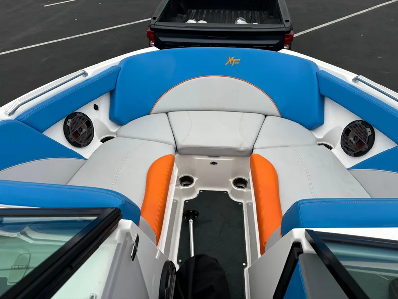Slide: The Image of 2020 MasterCraft XT22 boat interior with blue and orange seating. - 5