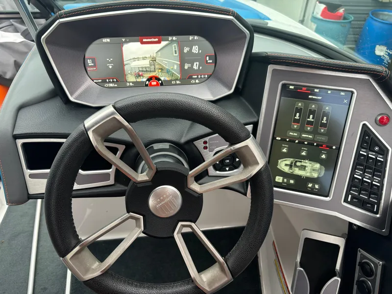 Slide: The Image of 2020 MasterCraft XT22 dashboard with modern steering wheel and digital displays. - 7