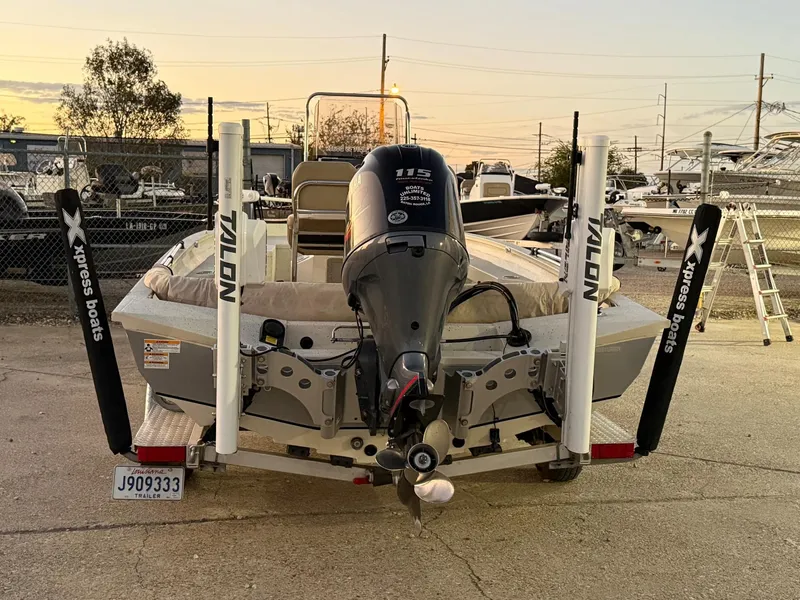 Slide: The Image of 2020 Xpress H20B boat with Talon anchors and Yamaha engine at sunset. - 10