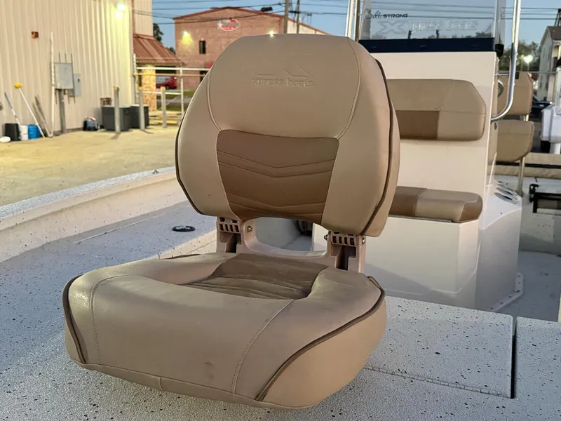 Slide: The Image of Xpress H20B 2020 boat seat, beige leather, outdoor setting. - 12