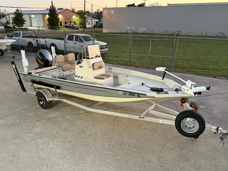 Slide: The Image of 2020 Xpress H20B boat on trailer, parked outdoors, ready for transport. - 13