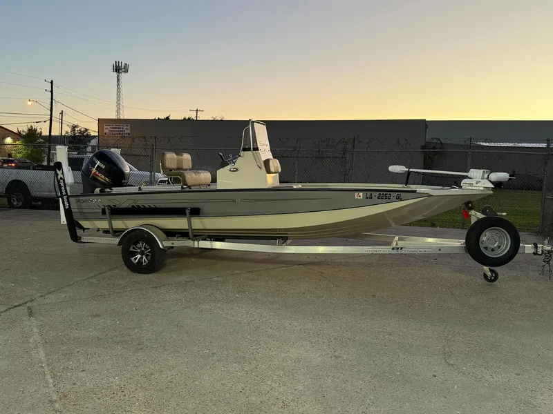 Slide: The Image of 2020 Xpress H20B boat on trailer at sunset, parked outdoors. - 14