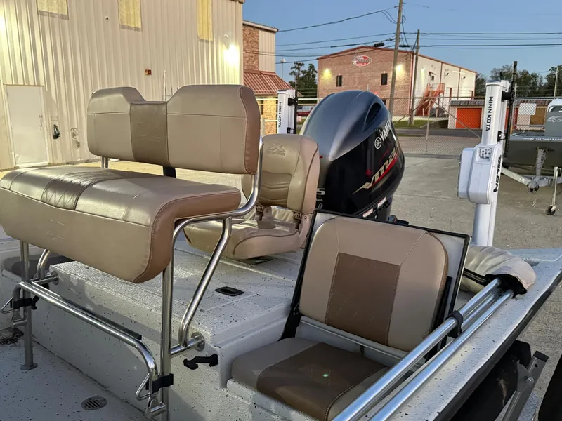 Slide: The Image of 2020 Xpress H20B boat with Yamaha outboard motor and beige seating, parked outdoors. - 16