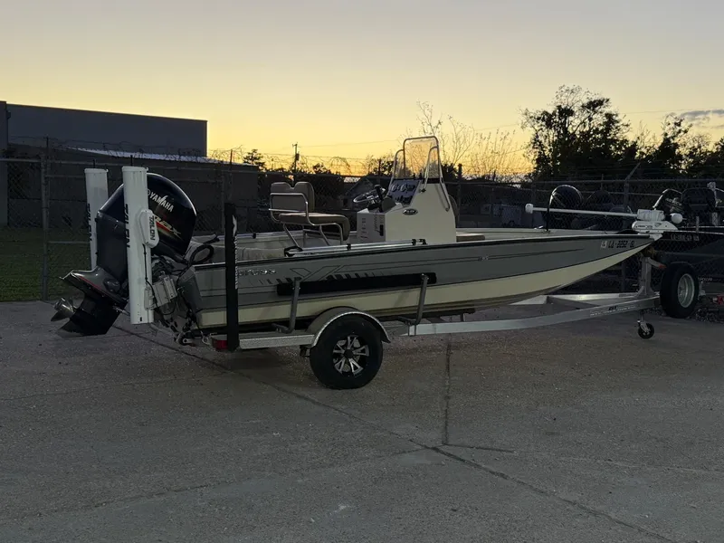 Slide: The Image of 2020 Xpress H20B boat on trailer at sunset, parked outdoors. - 19