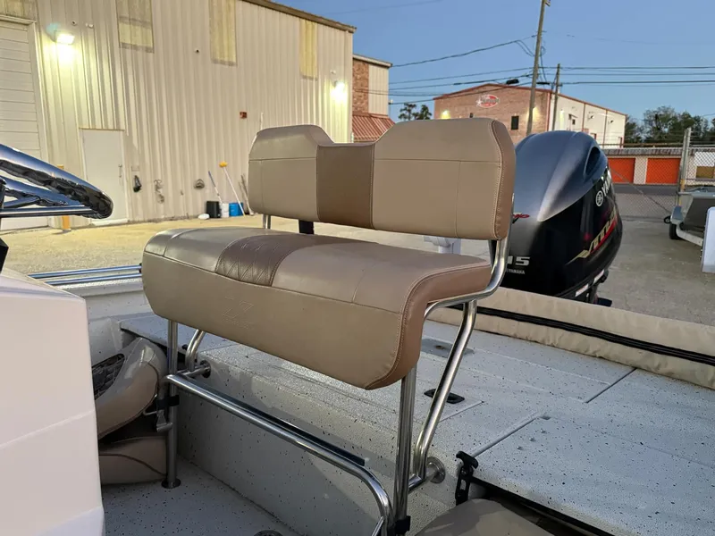 Slide: The Image of 2020 Xpress H20B boat with beige seating and Yamaha outboard motor in a marina setting. - 6