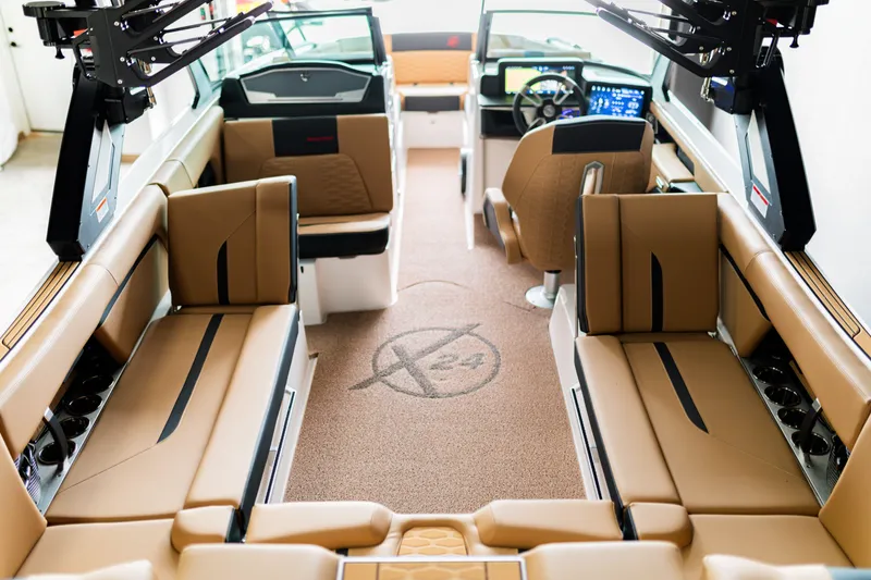 Slide: The Image of Luxurious 2025 MasterCraft X24 boat interior with tan seating and modern dashboard. - 7