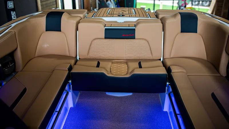 Slide: The Image of Luxurious interior of 2025 MasterCraft X24 boat with tan leather seats and blue LED lighting. - 8