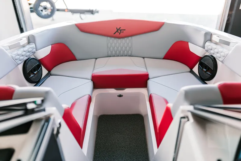 Slide: The Image of 2025 MasterCraft XT22 boat interior with red and gray seating. - 2