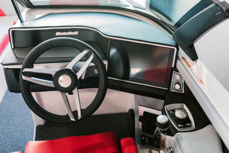 Slide: The Image of 2025 MasterCraft XT22 boat dashboard with steering wheel and digital display. - 3