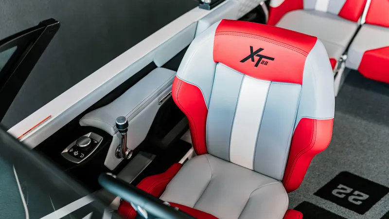 Slide: The Image of 2025 MasterCraft XT22 boat interior with red and gray seating. - 5