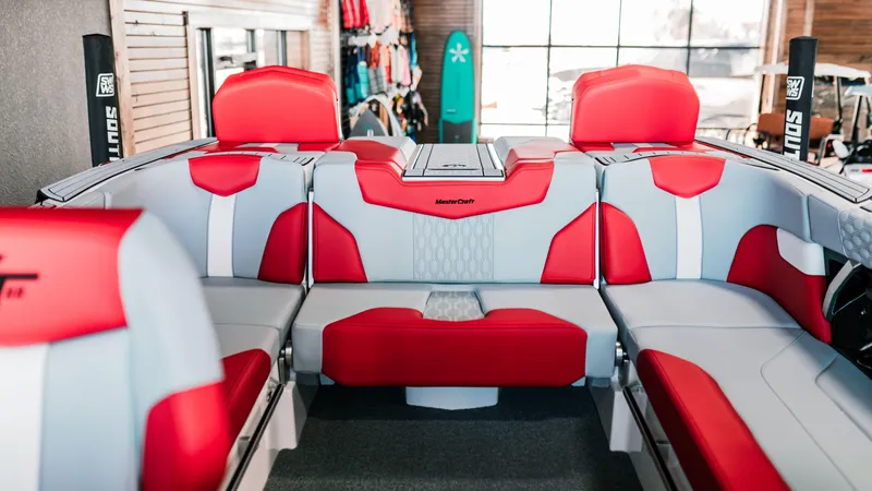 Slide: The Image of 2025 MasterCraft XT22 boat interior with red and gray seating. - 6