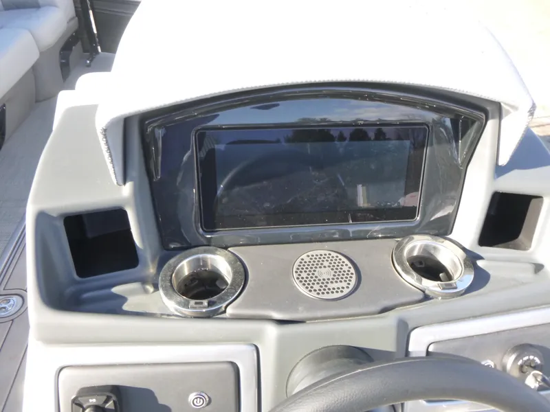 Slide: The Image of Dashboard of 2025 Regency 230 LE3 boat with cup holders and display screen. - 15