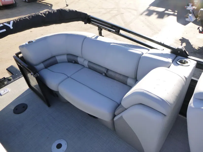 Slide: The Image of 2025 Regency 230 LE3 boat with luxurious gray seating and cup holders. - 19