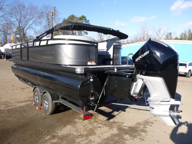 Slide: The Image of 2025 Regency 230 LE3 pontoon boat with Mercury outboard engine on trailer. - 4