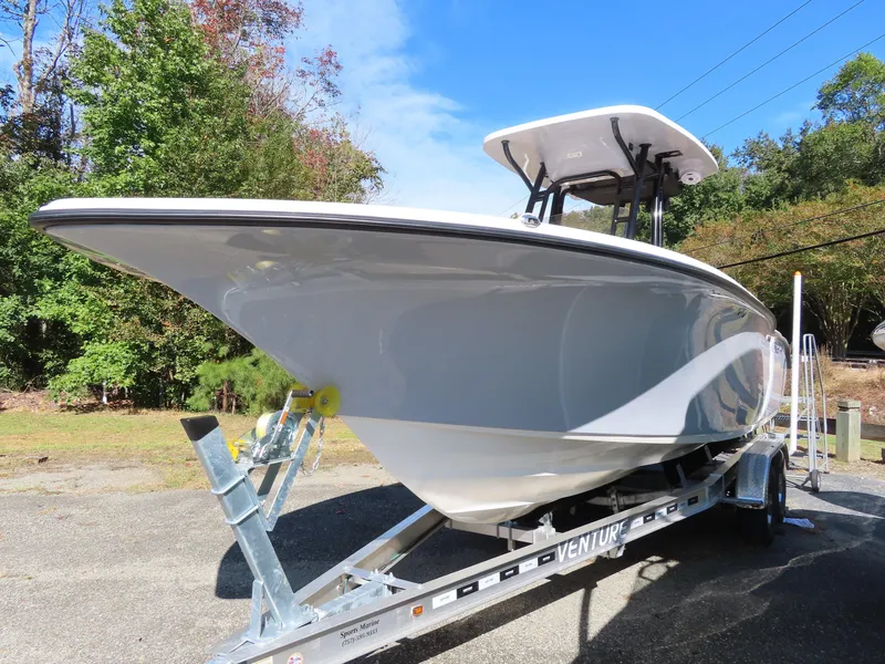 Slide: The Image of 2025 Key West 244 Center Console boat on trailer, parked outdoors. - 0