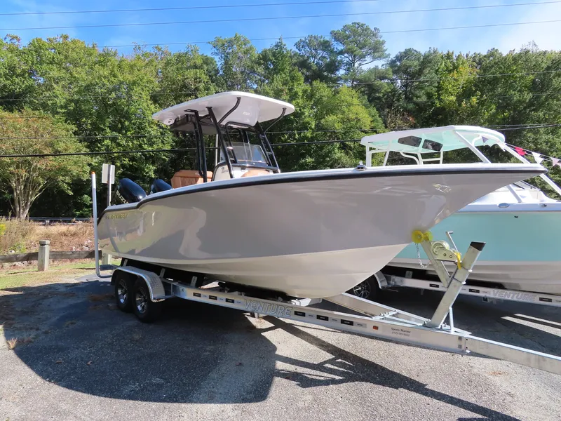 Slide: The Image of 2025 Key West 244 Center Console boat on trailer, parked outdoors. - 1