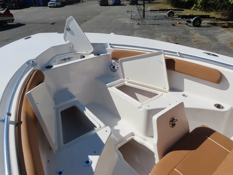 Slide: The Image of 2025 Key West 244 Center Console boat with open storage compartments and tan seating. - 10