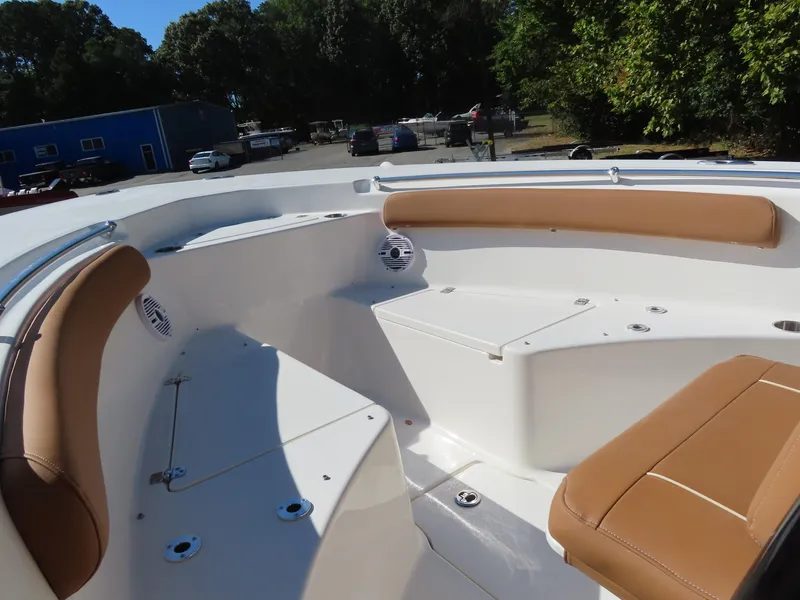 Slide: The Image of 2025 Key West 244 Center Console boat interior with tan seating and white deck. - 11
