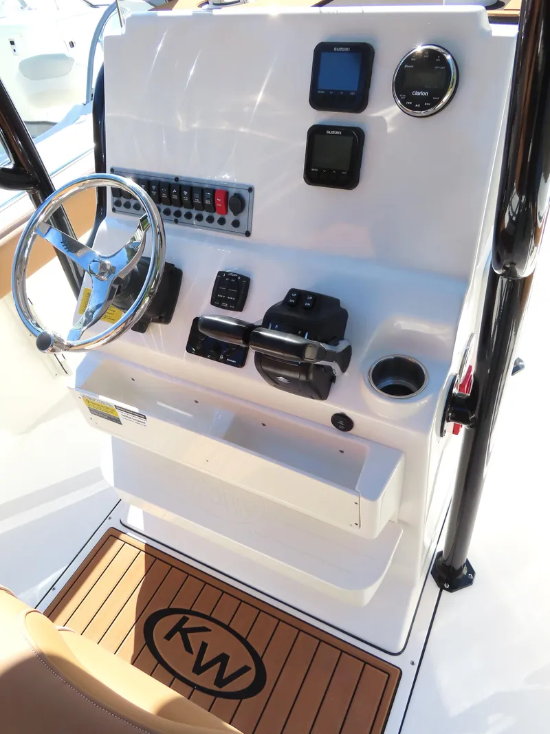 Slide: The Image of 2025 Key West 244 Center Console boat dashboard with steering wheel and controls. - 12