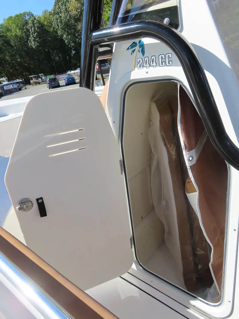 Slide: The Image of 2025 Key West 244 Center Console boat storage compartment open. - 17