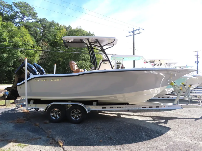Slide: The Image of 2025 Key West 244 Center Console boat on trailer, parked outdoors. - 2